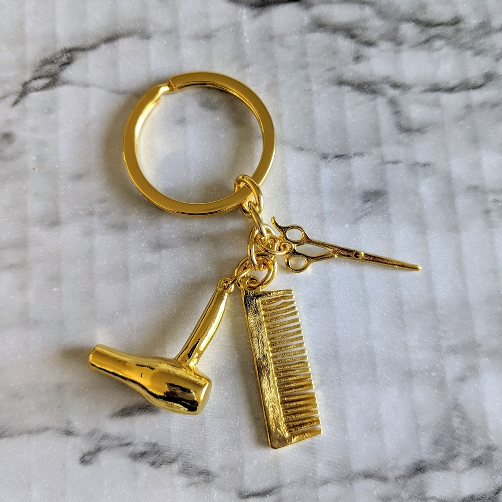 Gold color hair dresser keychain.